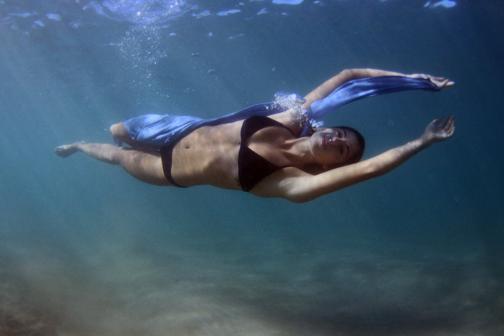 Model swimming underwater in a flowing Nalu Blue sarong