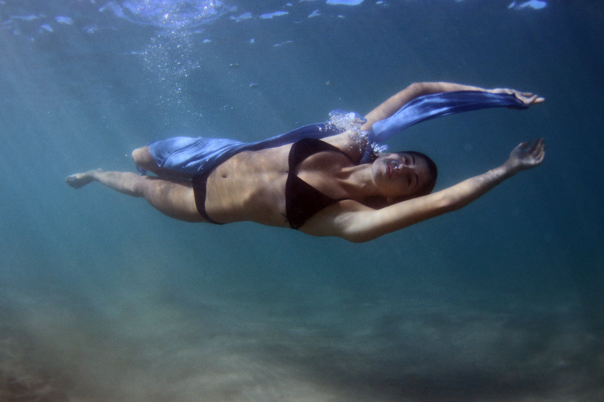Model swimming underwater in a flowing Nalu Blue sarong